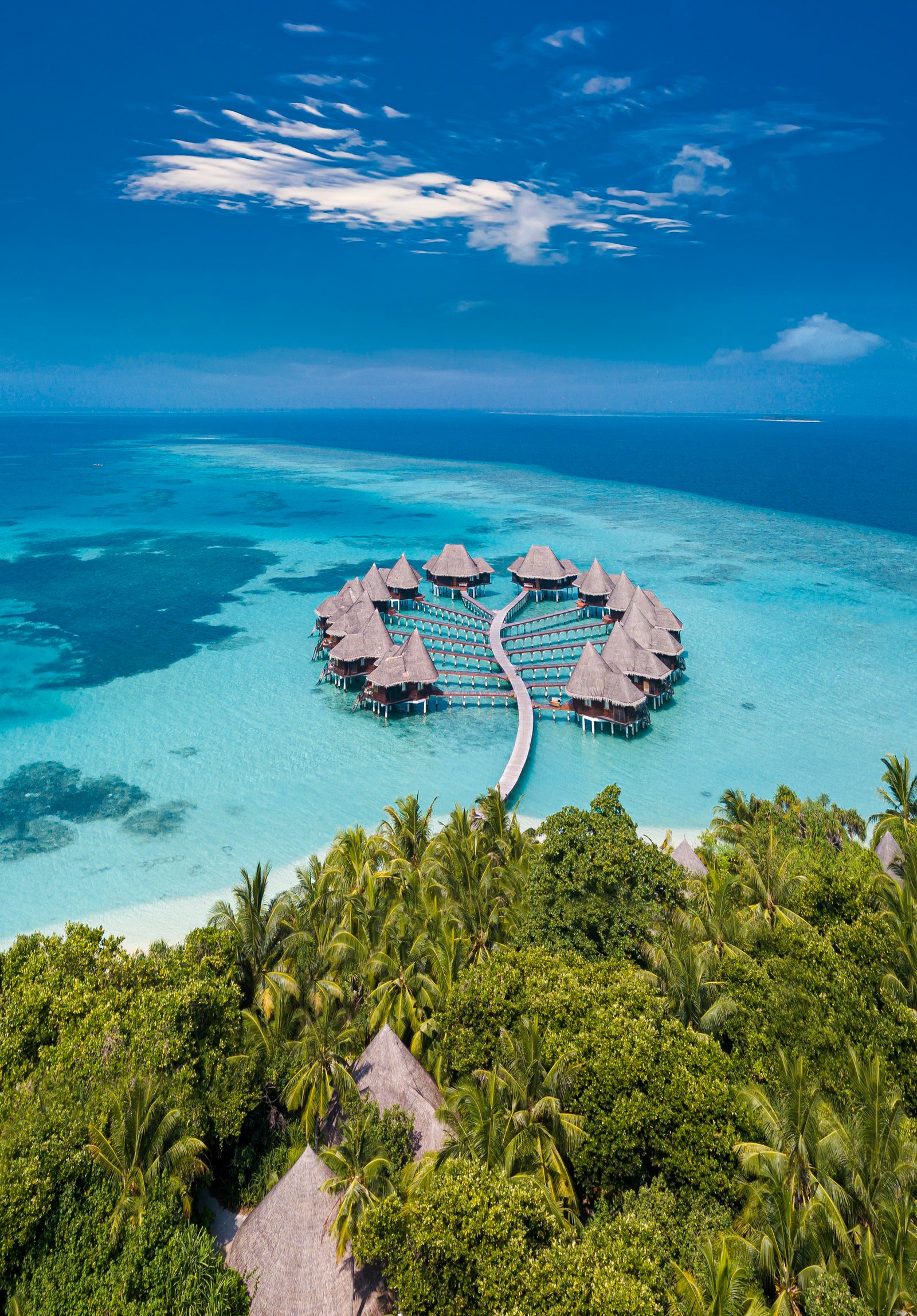 Luxury overwater villas extending over a turquoise lagoon in the Maldives
