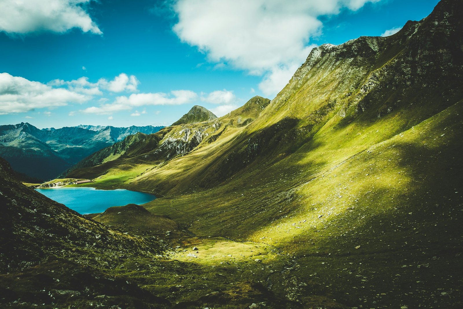Green Swiss Alpine slopes above Lake Cadagno